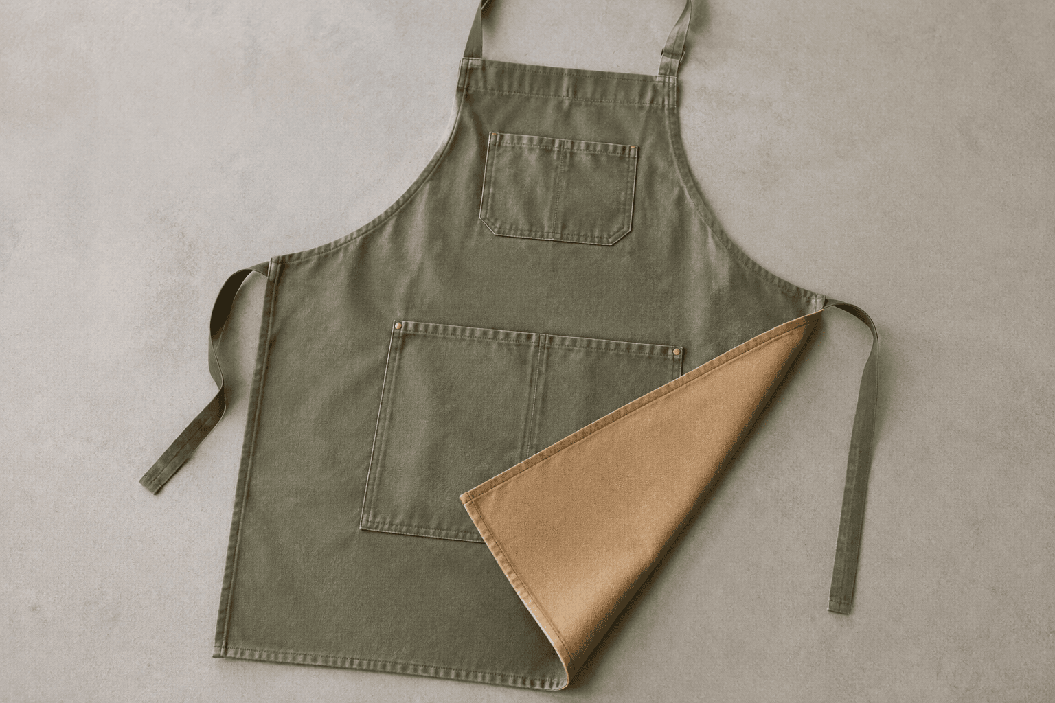 An apron folded back to reveal its inner lining layer on a worktable
