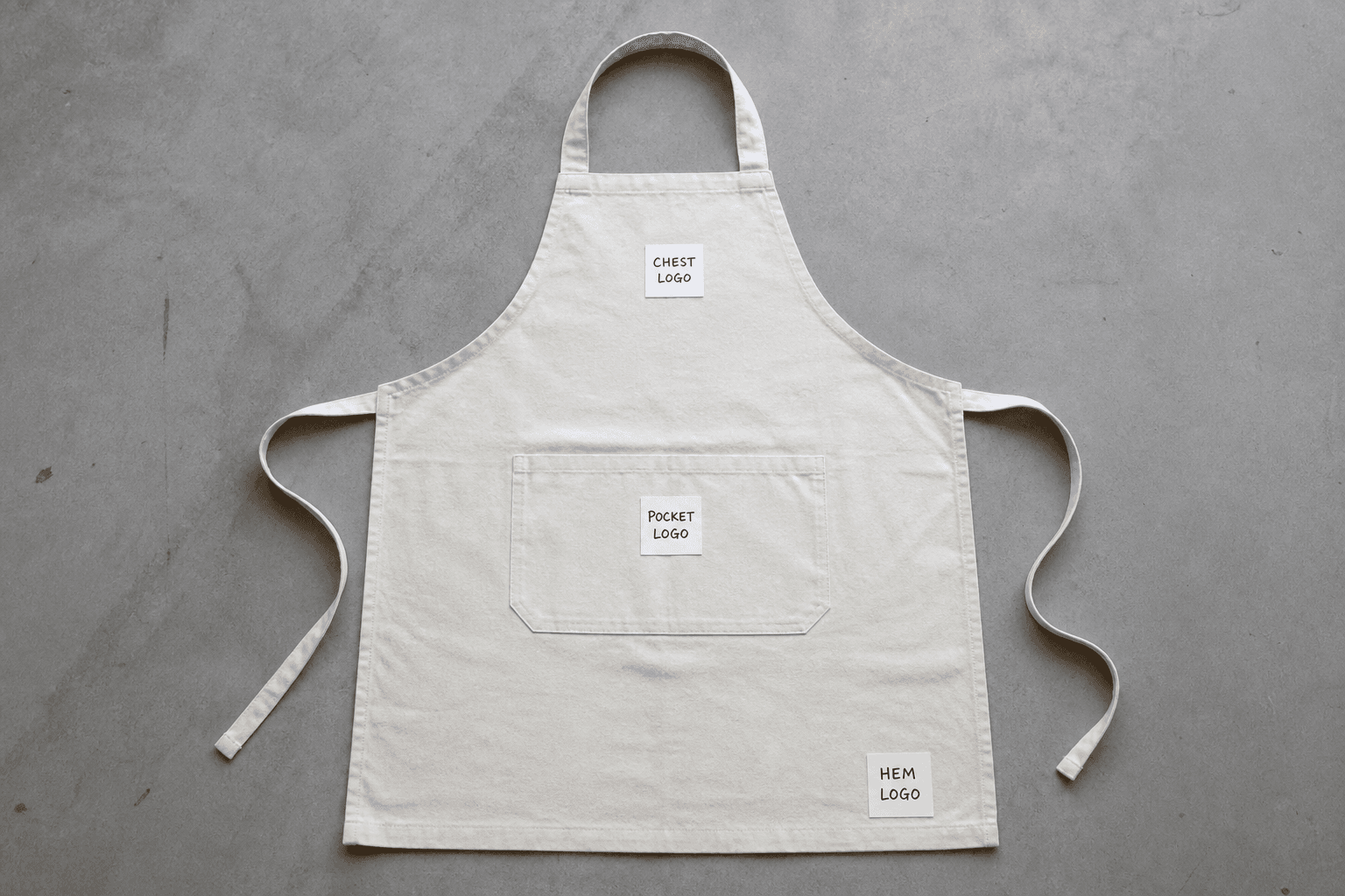An apron laid flat marked with several common logo placement zones