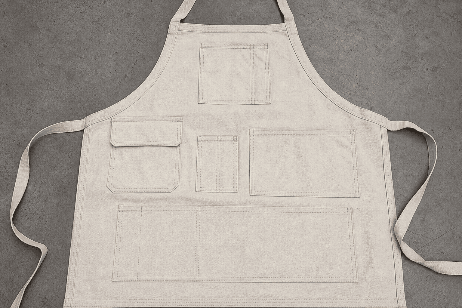 An apron front showing multiple stitched pocket configurations