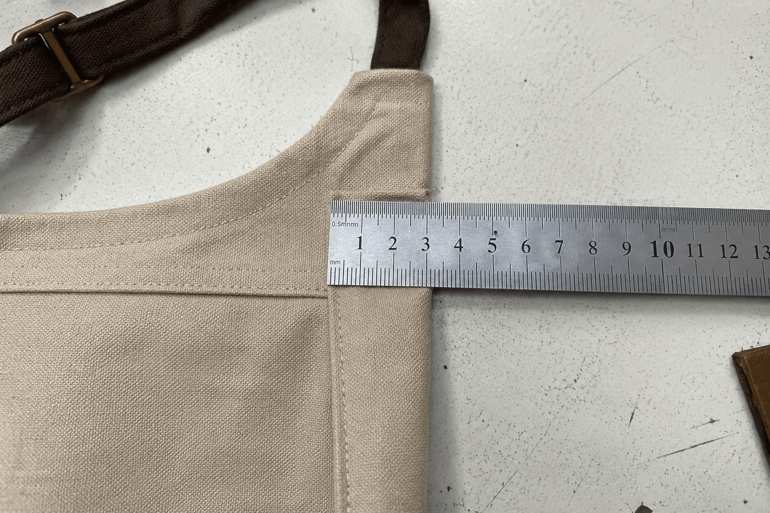close-up of apron seam allowance measurement with ruler on a sewn sample