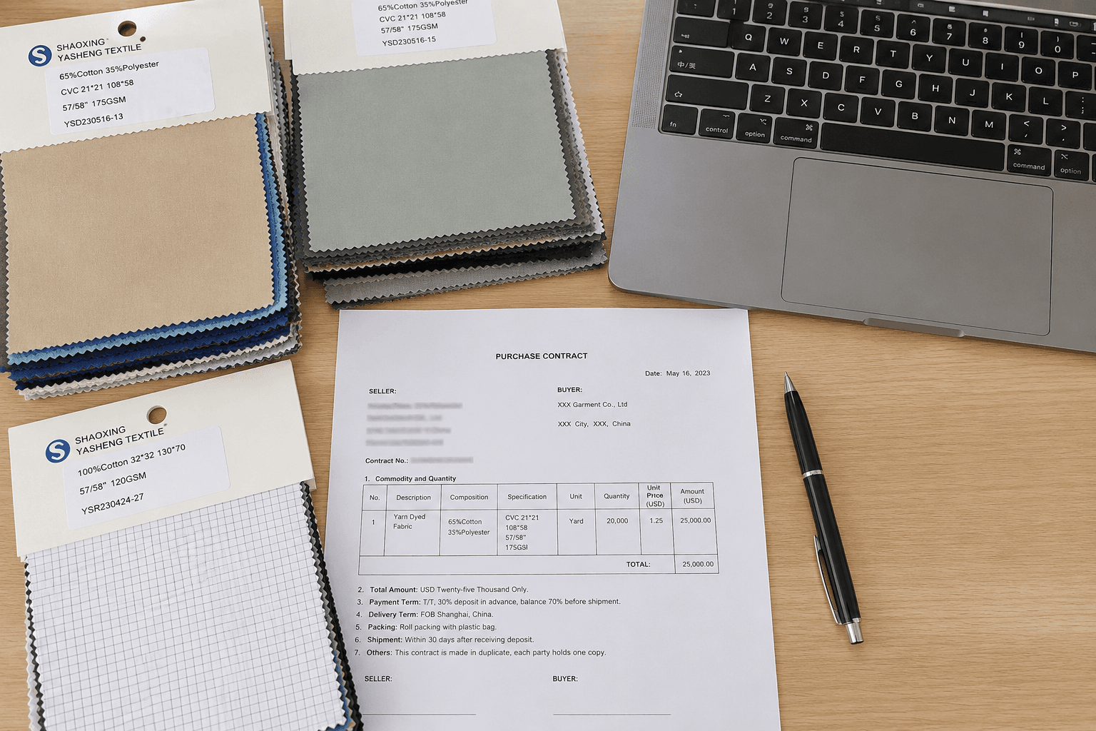 A sourcing desk with fabric swatches, a contract and a laptop