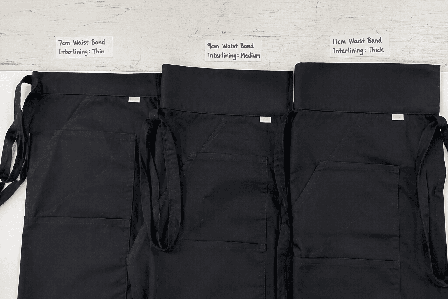 waist apron samples showing different waistband heights and interlining thicknesses