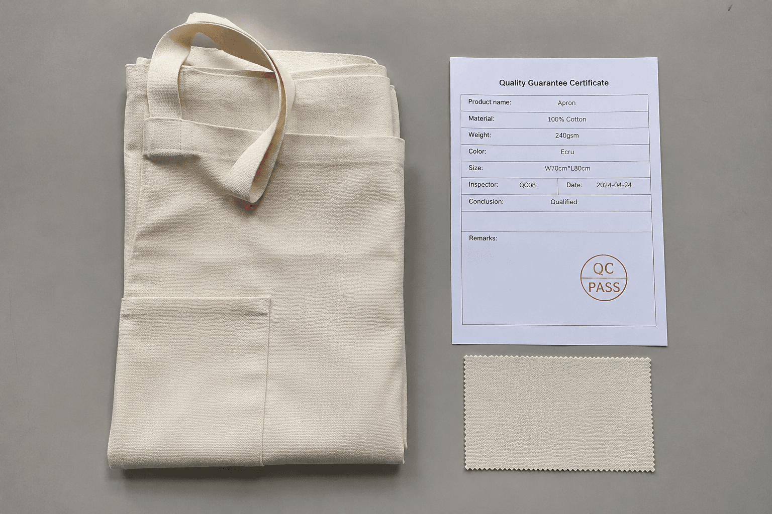 A folded apron beside a printed quality guarantee certificate