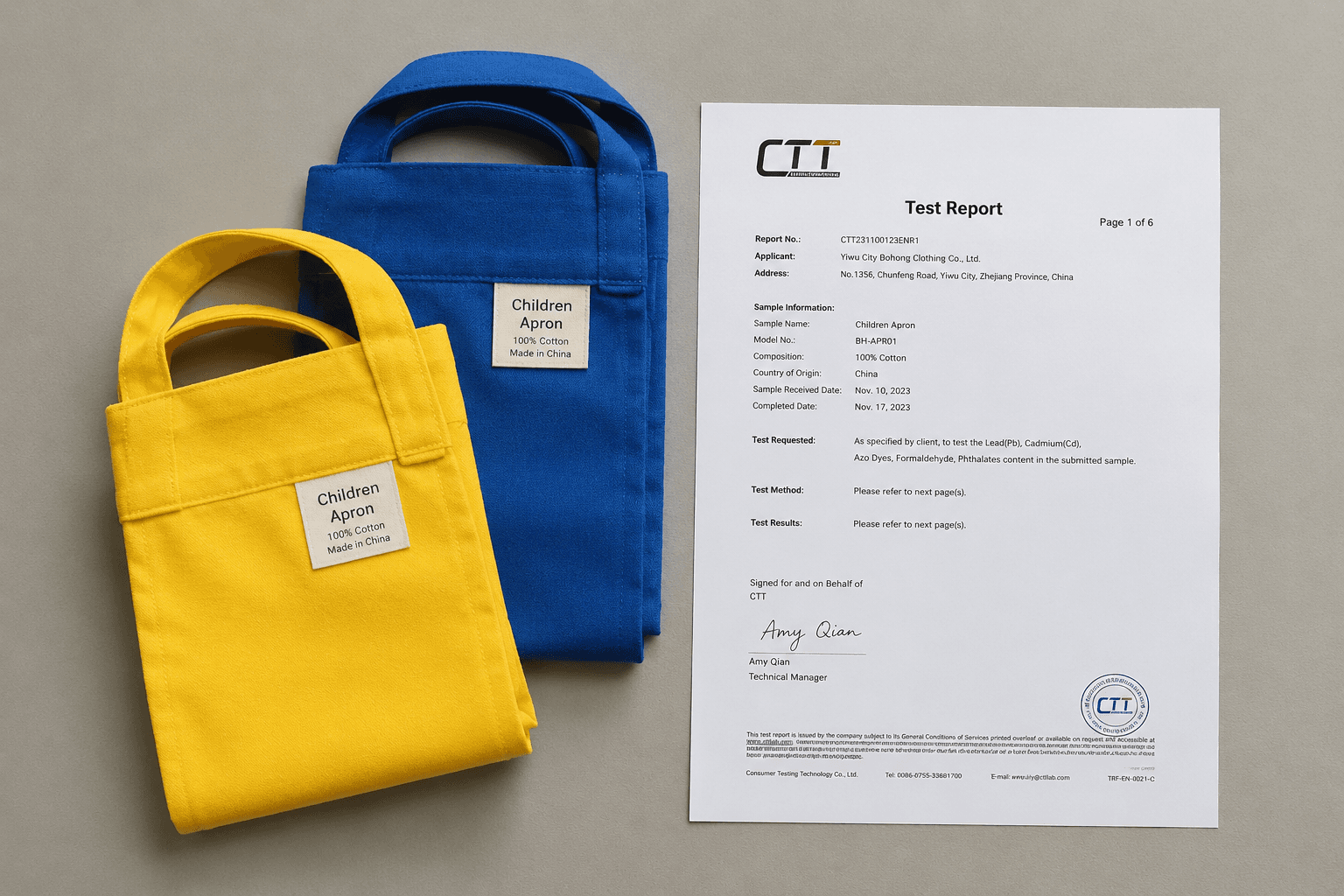 Small children's aprons folded beside a safety compliance document