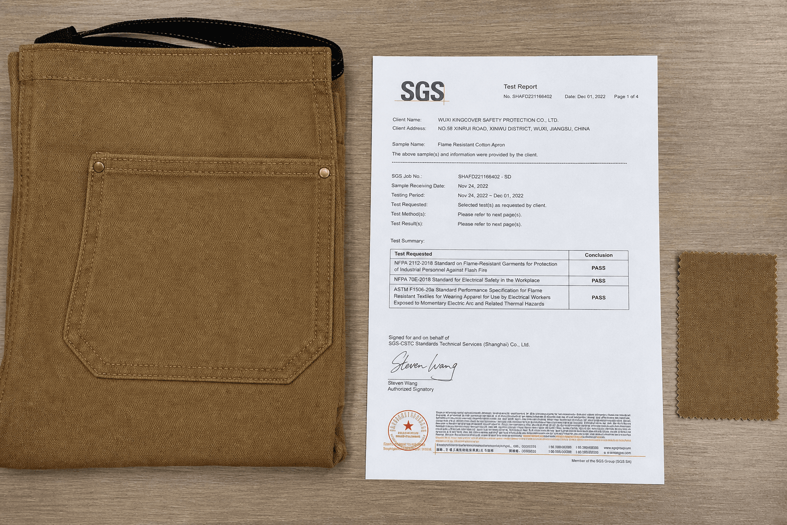An FR-treated apron with a compliance test report on a desk