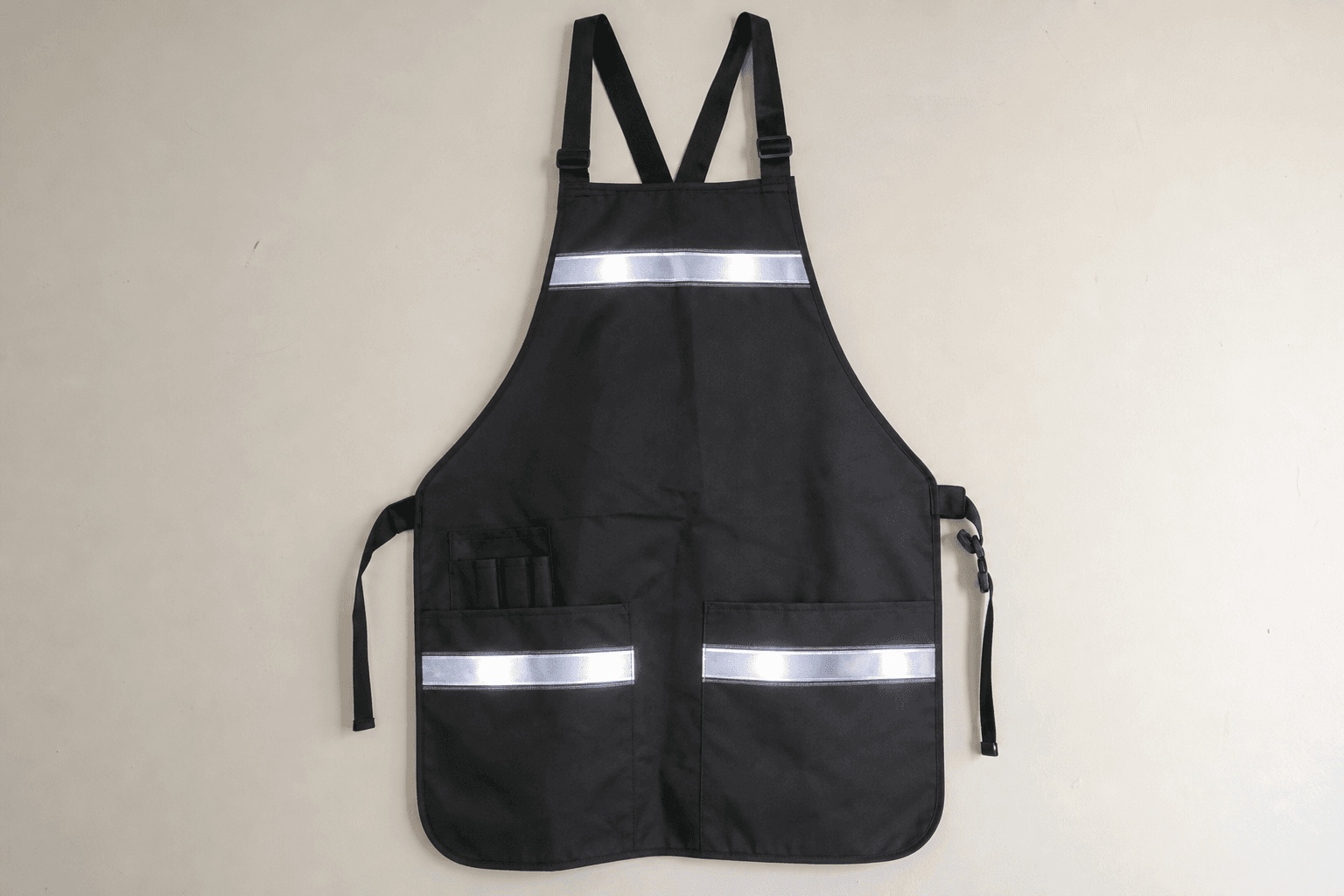 A dark apron with reflective trim strips catching the light
