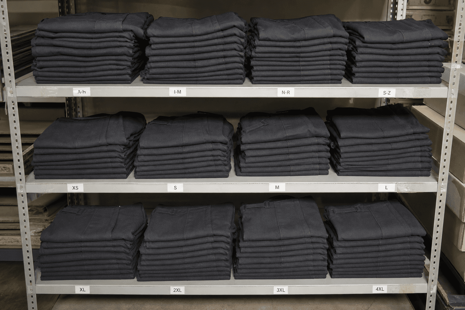 Identical folded aprons stacked in a warehouse for restock