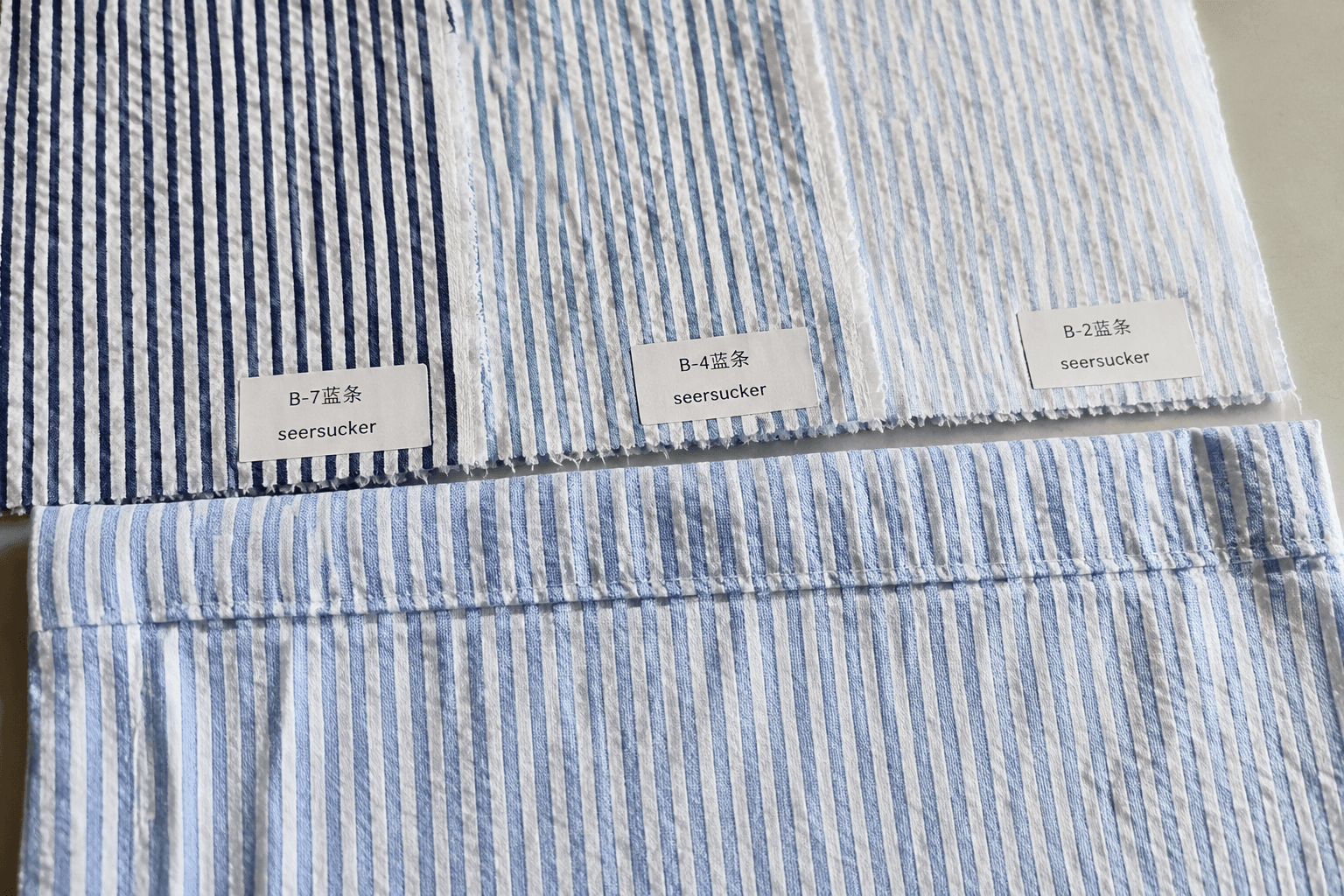 striped seersucker apron fabric swatches showing puckered texture and sewn hem sample