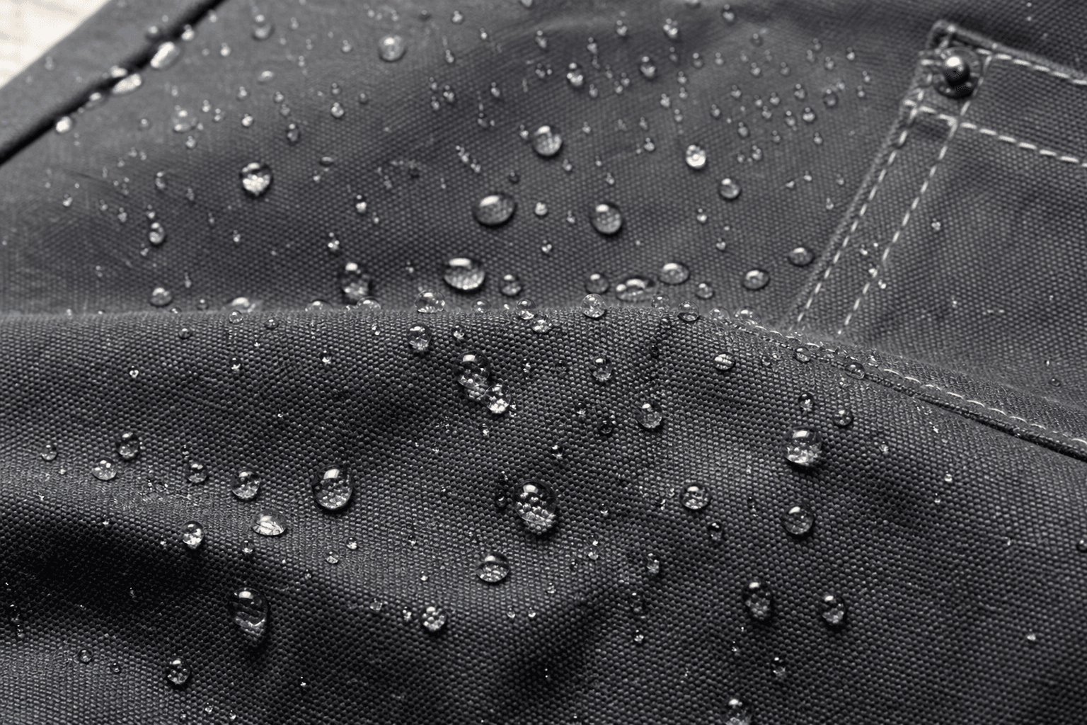 Water beading on the surface of a treated canvas apron